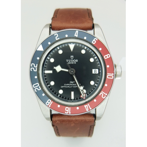 A Tudor Black Bay GMT 'Pepsi' Automatic Gents Watch. Brown leather strap with fold-over clasp. Stainless steel case - 41mm. Black dial with date window. Rotating Pepsi coloured bezel. In working order. Comes with box and an array of papers. Ref: 020736.
