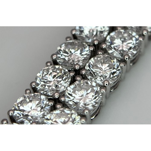 26 - A W.G.I Certified 10K White Gold, Diamond Tennis Necklace. Set with 114 round brilliant lab grown di... 