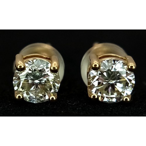 509 - A Pair of 18K Yellow Gold and Diamond Stud Earrings. 0.80ctw of round brilliant cut diamonds having ... 