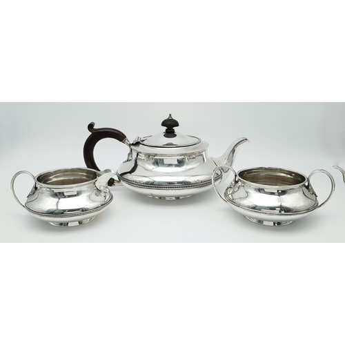 A HALLMARKED SILVER REGENCY STYLE TEA SET COMPRISING OF AN ELEGANT TEAPOT , CREAMER AND SUGAR BOWL AND DATED 1922 .   TOTAL WEIGHT  840.3gms