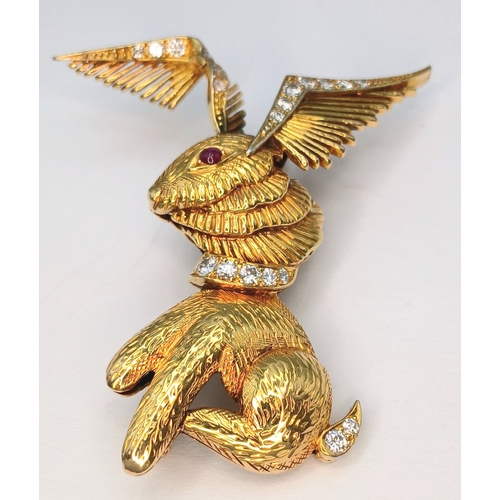 An 18K Yellow Gold (tests as) and Diamond Winged Rabbit with Ruby Eye Brooch. 5cm x 4cm ear-span! 13.4g total weight.