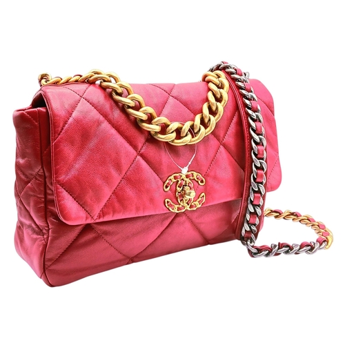 A Chanel Lambskin Quilted Large Chanel 19 Flap Bag. Deep red/burgundy quilted lambskin leather exterior with mixed-tone hardware, including aged gold-tone and silver-tone chunky chain details. Leather-interwoven chain top handle and shoulder strap with shoulder pad, a rear magnetic closure slip pocket, and a signature CC turn-lock flap closure. Red textile interior with one main compartment and a zipped inner side pocket. Comes with dust cover bag, box and authenticity card. Approx. 30cm length x 20cm height x 8cm depth. Signs of tarnishing to the hardware, but in good overall condition. Please see photos or request a condition report. Ref: 28138.