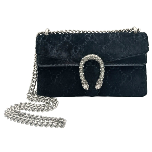 A Gucci Velvet GG Monogram Dionysus Shoulder Bag. Black GG monogram velvet exterior with black patent leather trim, silver-toned hardware, chain shoulder strap and tiger head spurred horseshoe front detail. Press-lock closure, flap opens to a beige suede interior with partitioned compartments. Size approx: 24.5cm length x 14.5cm height. In good overall condition with some minor stains to the interior - Please see photos or request a condition report. Ref: 26616