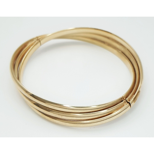 50 - A 9K Yellow Gold Twist Bangle. 14mm widest part. Clip open design. Two small dings. 55mm inner diame... 
