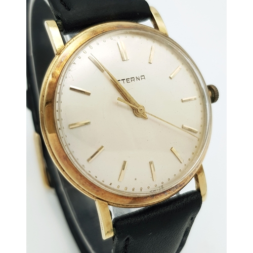46 - A Vintage 18K Gold Eterna Mechanical Gents Watch. Black leather strap. 18K Gold case - 34mm. Swiss m... 