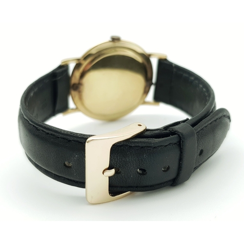 46 - A Vintage 18K Gold Eterna Mechanical Gents Watch. Black leather strap. 18K Gold case - 34mm. Swiss m... 