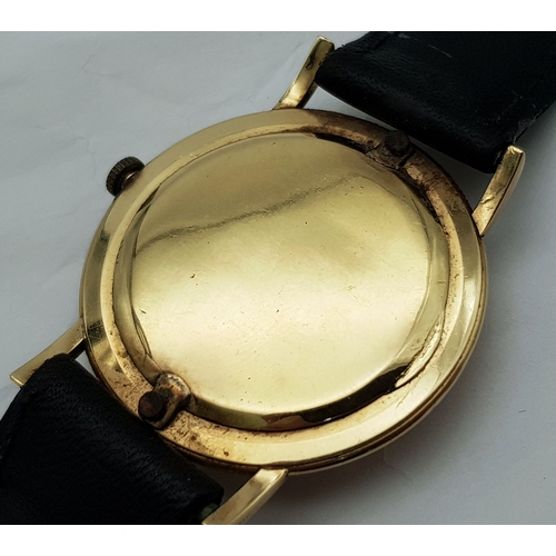 46 - A Vintage 18K Gold Eterna Mechanical Gents Watch. Black leather strap. 18K Gold case - 34mm. Swiss m... 