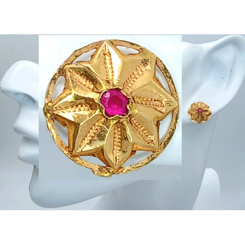 30 - A Pair of 18K Yellow Gold (tests as) and Ruby Floral Form Stud Earrings. 1.6g total weight.