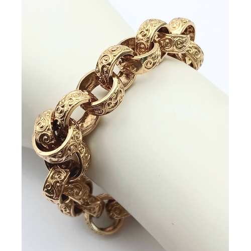 51 - A Chunky 9K Gold Statement Bracelet with Circular, Intricate Pattern Engraved Links. Large lobster c... 