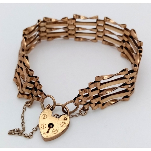 29 - A Vintage 9K Yellow Gold Gate Bracelet with Heart Clasp and safety chain. 11mm width. 18cm. 12.2g.
