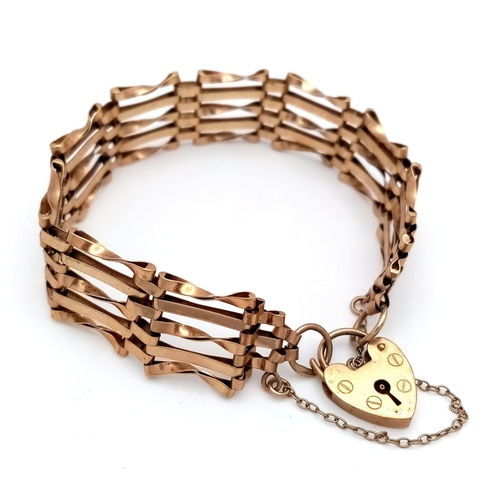 29 - A Vintage 9K Yellow Gold Gate Bracelet with Heart Clasp and safety chain. 11mm width. 18cm. 12.2g.