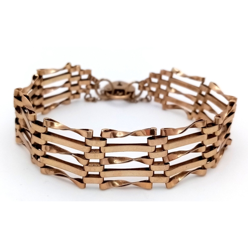 29 - A Vintage 9K Yellow Gold Gate Bracelet with Heart Clasp and safety chain. 11mm width. 18cm. 12.2g.