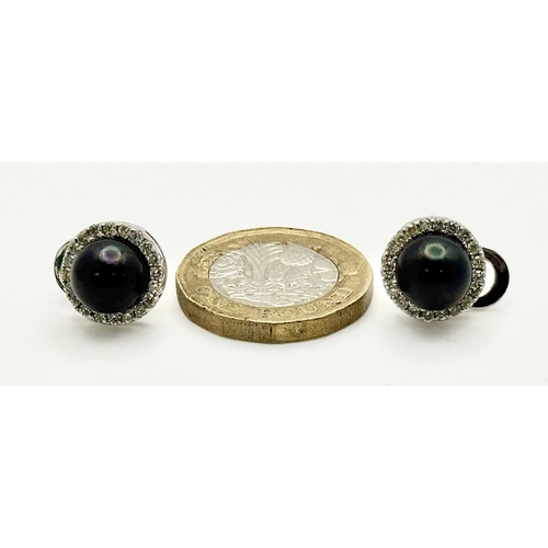 47 - A Pair of 14K White Gold Tahitian Pearl and Diamond Stud Earrings. Beautiful 8mm pearls with diamond... 