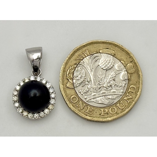 19 - A 14K White Gold Pendant with Black Pearl and Diamond Surround. c. 0.20ctw diamonds. 2cm. 2.95g tota... 
