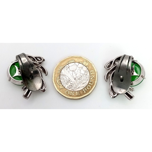 197 - A Stunning Pair of Jade and Diamond Earrings - Each having a circular jade piece with a 0.20ct round... 