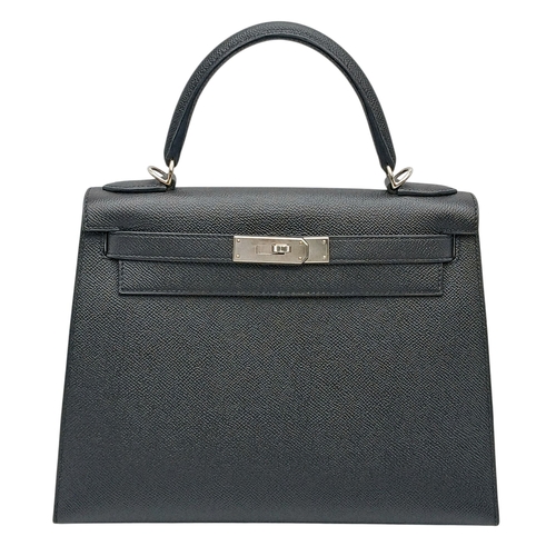 A Highly Collectable Hermes Black Kelly 28 Bag. Epsom leather exterior with silver-toned hardware top handle, four protective base studs and postman's lock closure. Black leather interior with a zipped side pocket and two open side pockets. Comes with detachable shoulder strap (83cm), clochette, padlock and keys. Plus box, dust cover, certificate of authenticity and protective bag raincoat. Approximately 28 cm length x 22 cm height. Please see photos or request a condition report. Ref: 030143