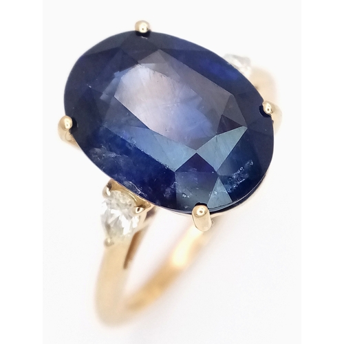 An IGI Certified 18K Yellow Gold (tests as) Sapphire and Diamond Cocktail Ring. An 8.05ct natural oval mixed cut sapphire flanked by two pear cut diamonds - 0.26ctw having J-K colour and SI clarity. Size N 1/2. 4.63g total weight. Ref: LXR-90058