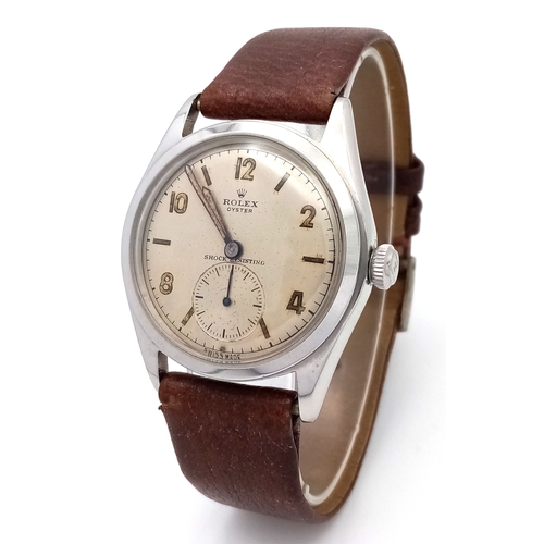 A Vintage Rolex Oyster Mechanical Gents Watch. Model 4499. Brown leather strap. Stainless steel case - 34mm. Cream dial with second sub dial. Pull-out, hand-wind feature. In working order. Ref: 029603.