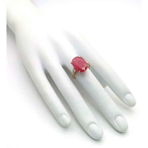 25 - An IGI Certified 18K Yellow Gold (tests as) Ruby and Diamond Cocktail Ring. A 14.29ct natural cushio... 