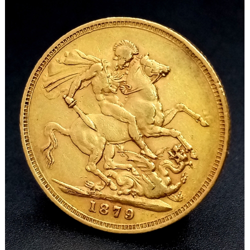 A FULL SOVEREIGN COIN DATED 1879 WITH THE YOUNG VICTORIA HEAD , MINTED IN MELBOURNE AND WITH THE UPSIDE DOWN REVERSE SIDE .