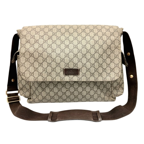 1017 - A Gucci GG Plus Monogram Messenger Diaper Bag. Beige and brown GG monogram coated canvas exterior wi... 