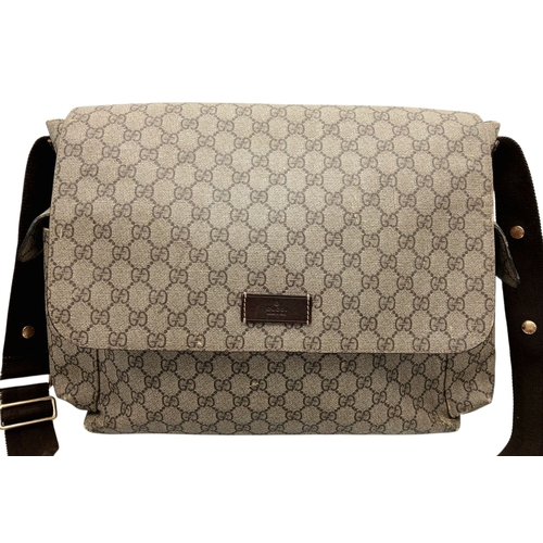 1017 - A Gucci GG Plus Monogram Messenger Diaper Bag. Beige and brown GG monogram coated canvas exterior wi... 
