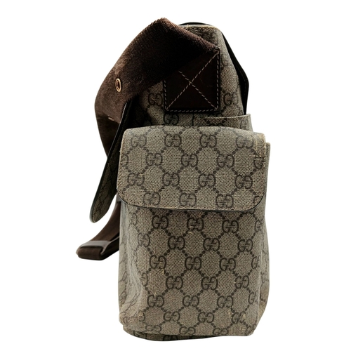 1017 - A Gucci GG Plus Monogram Messenger Diaper Bag. Beige and brown GG monogram coated canvas exterior wi... 