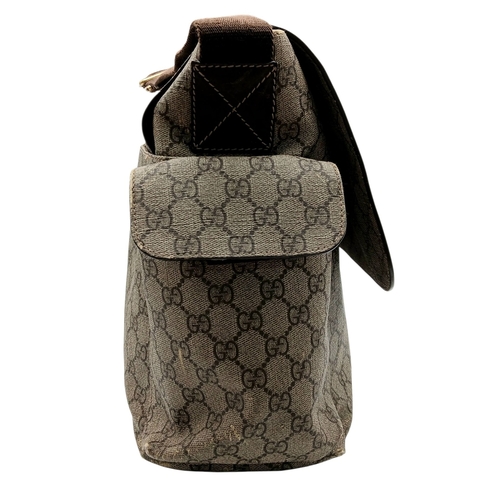 1017 - A Gucci GG Plus Monogram Messenger Diaper Bag. Beige and brown GG monogram coated canvas exterior wi... 