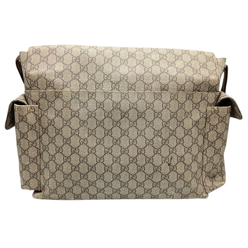 1017 - A Gucci GG Plus Monogram Messenger Diaper Bag. Beige and brown GG monogram coated canvas exterior wi... 