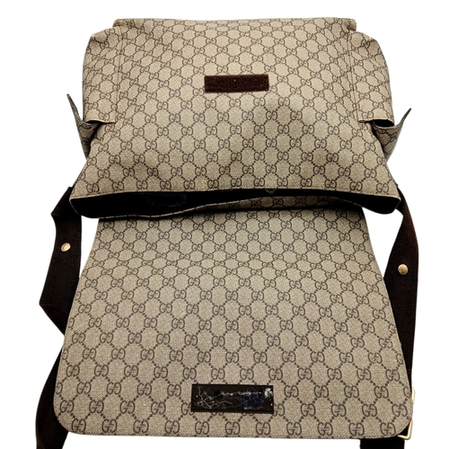 1017 - A Gucci GG Plus Monogram Messenger Diaper Bag. Beige and brown GG monogram coated canvas exterior wi... 
