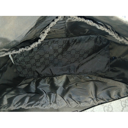 1017 - A Gucci GG Plus Monogram Messenger Diaper Bag. Beige and brown GG monogram coated canvas exterior wi... 