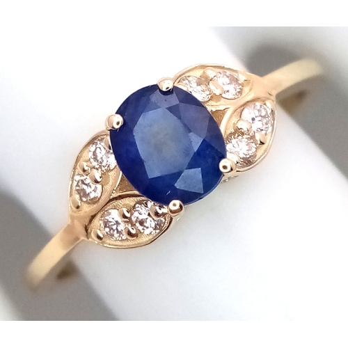 60 - A 14K Yellow Gold Natural Sapphire and Diamond Cocktail Ring. A 1.11ct oval cut sapphire with diamon... 