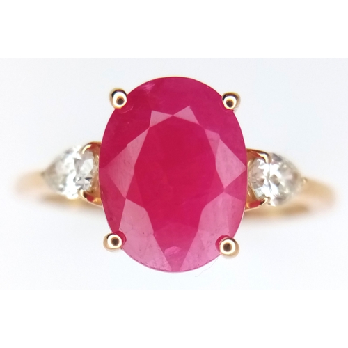 67 - A 14K Yellow Gold Natural Ruby and Diamond Cocktail Ring. A 2.71ct oval cut ruby with diamond accent... 