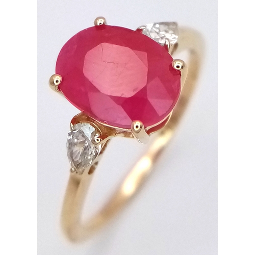 67 - A 14K Yellow Gold Natural Ruby and Diamond Cocktail Ring. A 2.71ct oval cut ruby with diamond accent... 