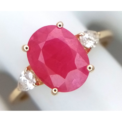 67 - A 14K Yellow Gold Natural Ruby and Diamond Cocktail Ring. A 2.71ct oval cut ruby with diamond accent... 