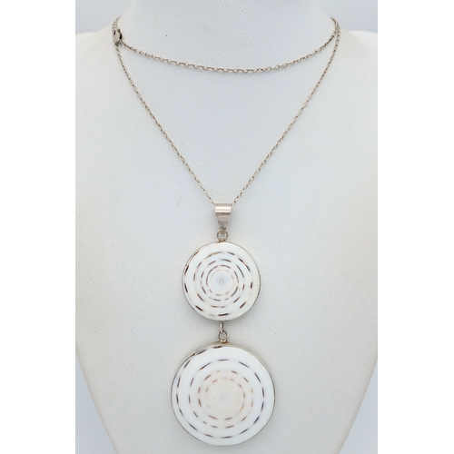 57 - A 925 silver necklace with a dual-disc pendant. Total weight 21g. Approx 84cm length with a 7cm pend... 