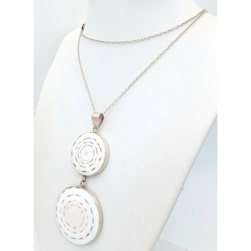 57 - A 925 silver necklace with a dual-disc pendant. Total weight 21g. Approx 84cm length with a 7cm pend... 