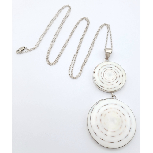 57 - A 925 silver necklace with a dual-disc pendant. Total weight 21g. Approx 84cm length with a 7cm pend... 