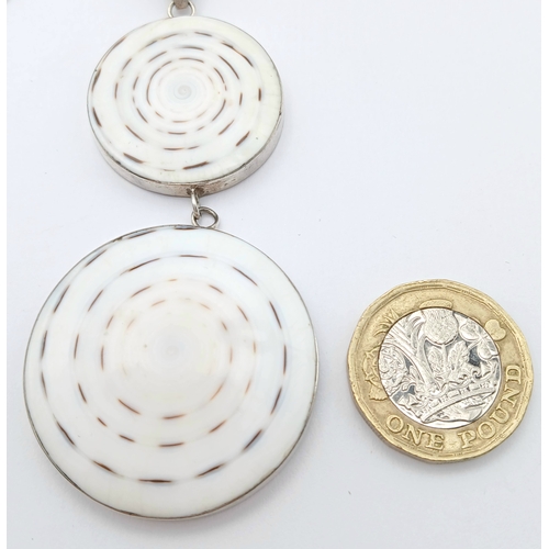 57 - A 925 silver necklace with a dual-disc pendant. Total weight 21g. Approx 84cm length with a 7cm pend... 