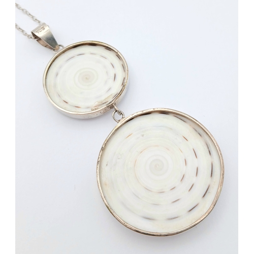 57 - A 925 silver necklace with a dual-disc pendant. Total weight 21g. Approx 84cm length with a 7cm pend... 