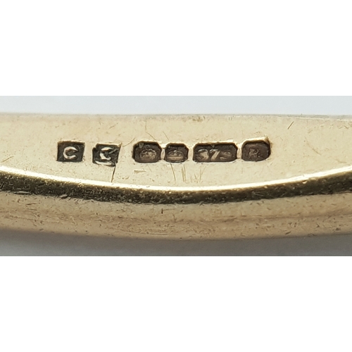 23 - A 9K Yellow Gold Multi-Faceted Gold Bangle. 4mm width. 63mm inner diameter. 15.75g