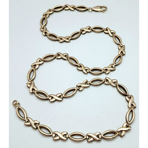 36 - A 9K Yellow Gold 'Hugs and Kisses' Chain Necklace. 42cm. 11.7g.