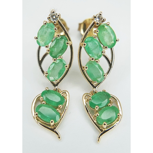 53 - A Pair of 14K Yellow Gold Natural Emerald and Diamond Drop Earrings. Ten oval natural emeralds total... 