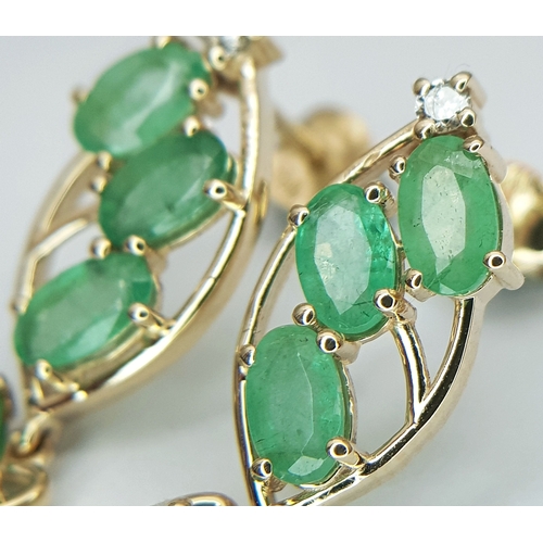 53 - A Pair of 14K Yellow Gold Natural Emerald and Diamond Drop Earrings. Ten oval natural emeralds total... 