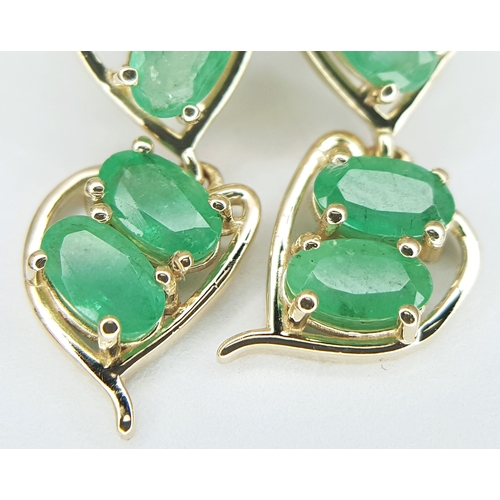 53 - A Pair of 14K Yellow Gold Natural Emerald and Diamond Drop Earrings. Ten oval natural emeralds total... 