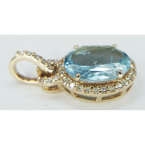 95 - A 14K Yellow Gold Natural Aquamarine and Diamond Pendant. A 1.15ct oval mixed cut natural aquamarine... 