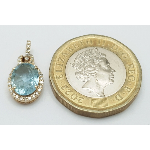 95 - A 14K Yellow Gold Natural Aquamarine and Diamond Pendant. A 1.15ct oval mixed cut natural aquamarine... 