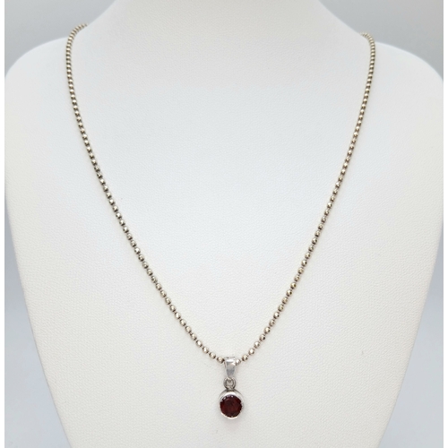 11 - A Beautiful 925 Sterling Silver Garnet Pendant Necklace - 46cm length. The pendant is set with a rou... 