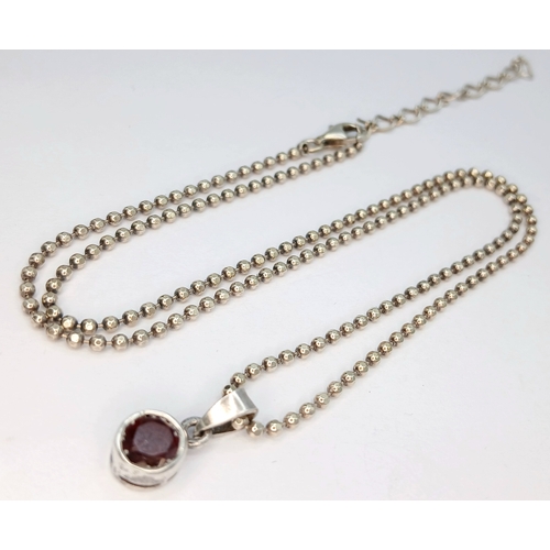 11 - A Beautiful 925 Sterling Silver Garnet Pendant Necklace - 46cm length. The pendant is set with a rou... 