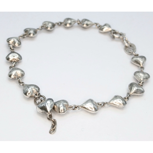 8 - A 925 Sterling Silver Heart Link Bracelet - 18cm length. Formed with a series of linked heart-shaped... 
